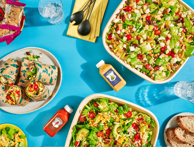 A large, catered salad being enjoyed